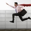 Businessman Wearing Cape --- Image by © Royalty-Free/Corbis
