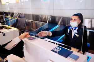 passenger giving his documents checkin airport manager by counter