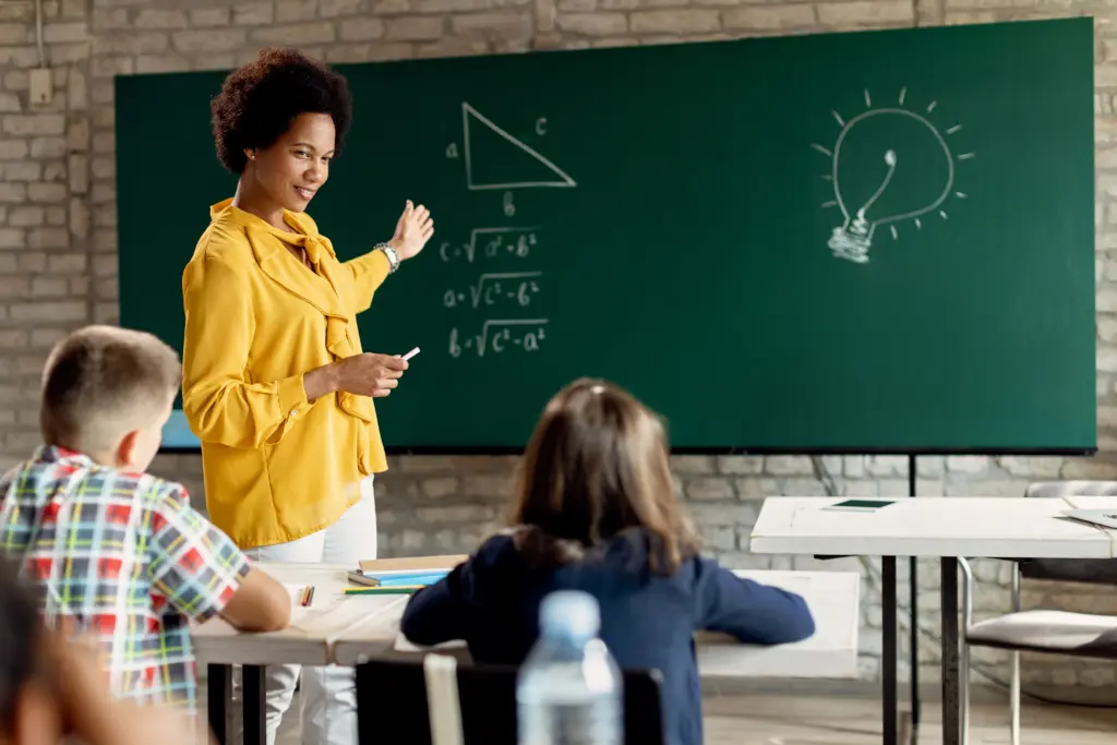 Concurso SEDF 2026: edital é prioridade de novo governo 1 happy black teacher teaching elementary students math classroom